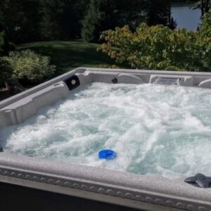 Hot Tub in backyard surrounded by greenery