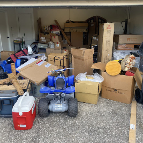 Garage filled with trash and cardboard and toys. Residential Junk Removal