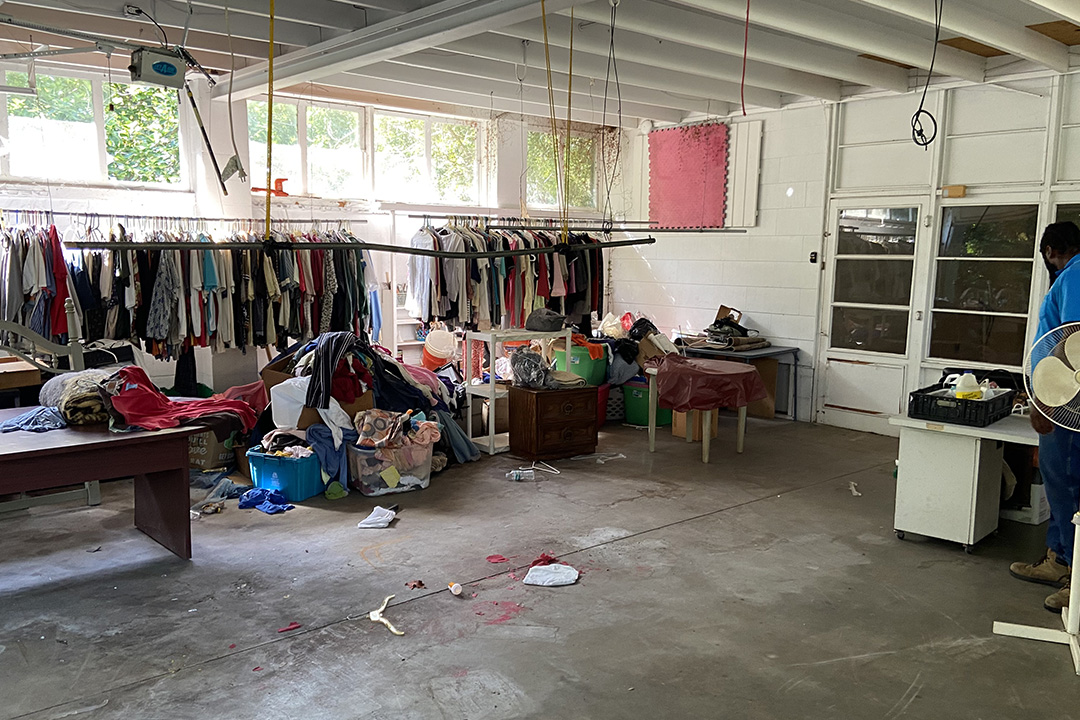Garage with clothes, furniture, and trash that needs to be hauled away